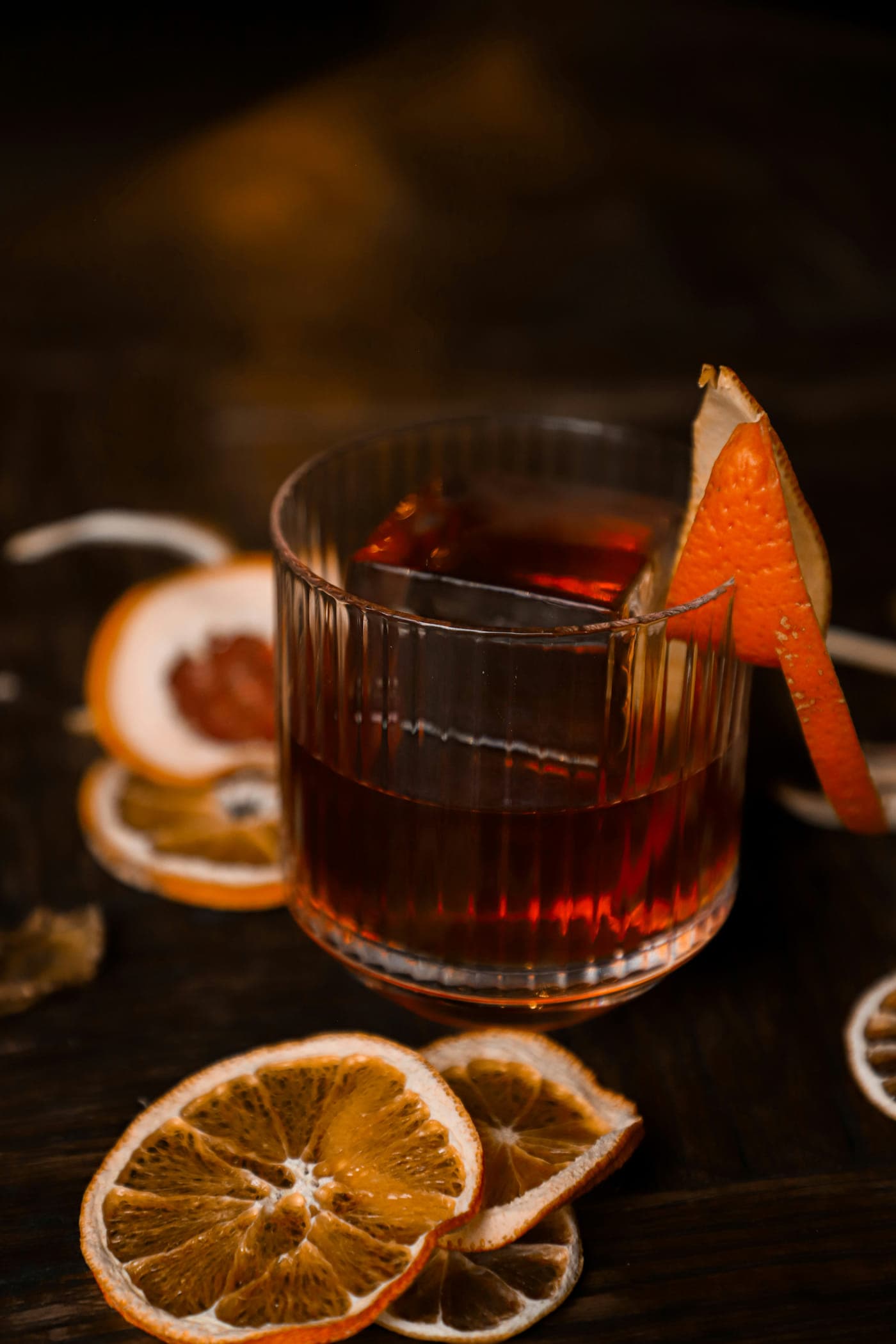 An amber negroni over ice with a twist of orange peel