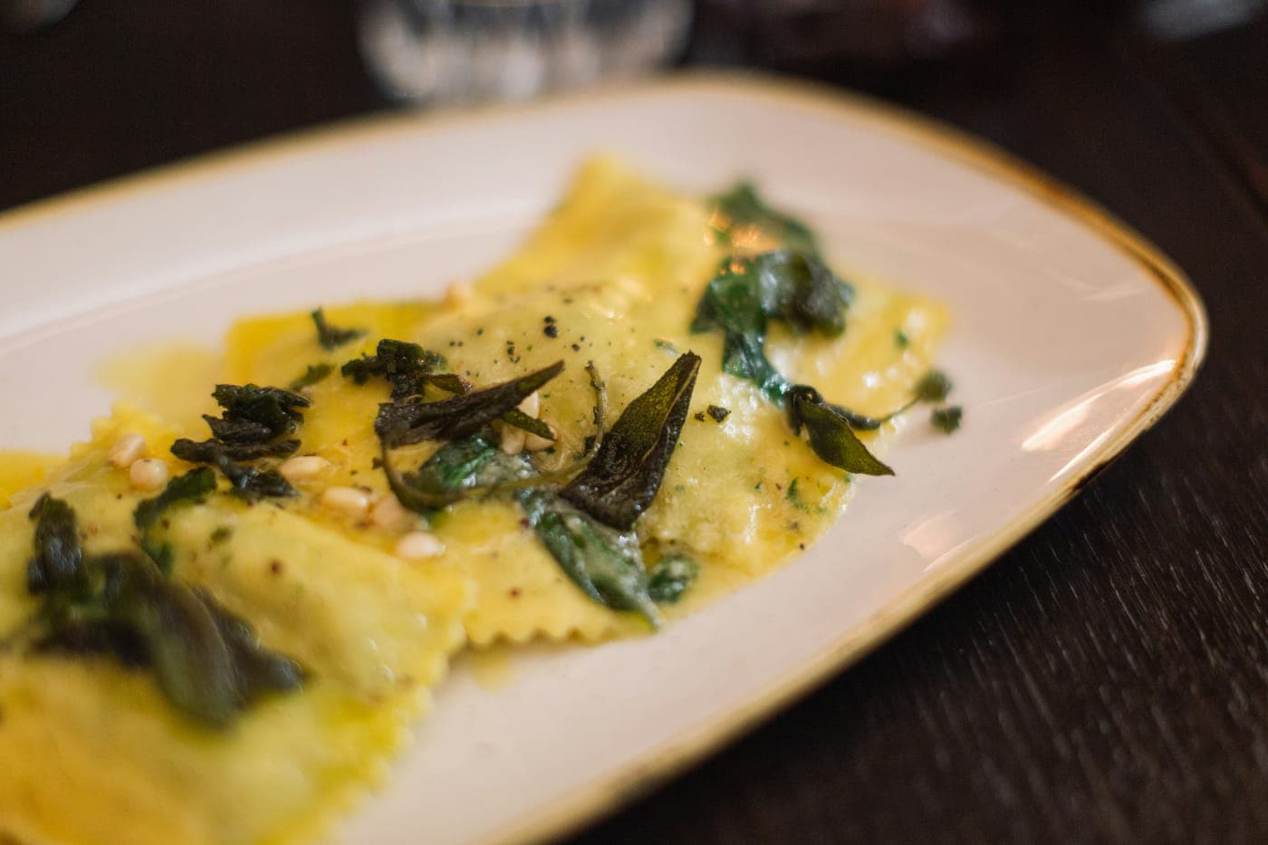Ravioli in brown butter with fried sage leaves and pine nuts